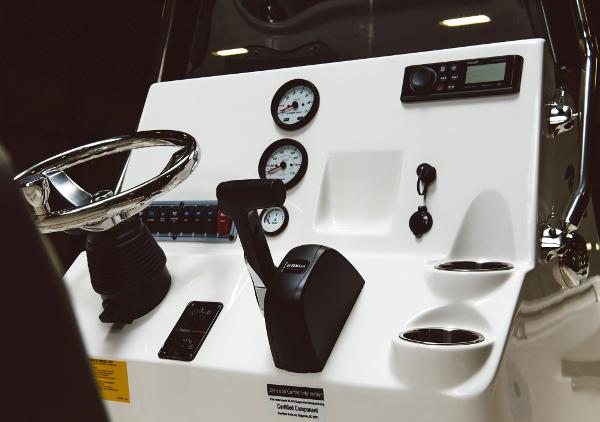 Slide: The Image of 2024 Key West 189 FS boat dashboard with steering wheel, gauges, and controls. - 46
