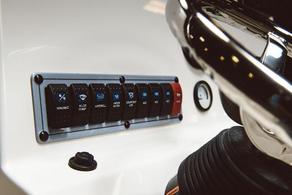Slide: The Image of Control panel of 2024 Key West 189 FS boat with labeled switches and gauge. - 48