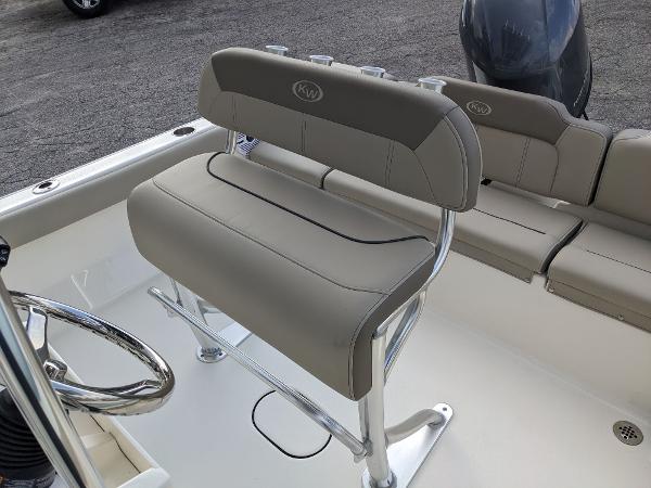 Slide: The Image of 2024 Key West 189 FS boat interior with cushioned seating and steering wheel. - 6