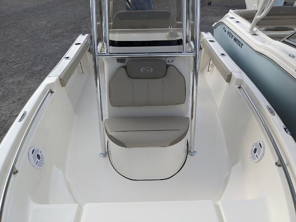 Slide: The Image of 2024 Key West 189 FS boat interior, front seating area with console and cushioned seats. - 8