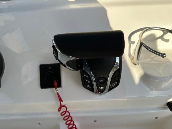 Slide: The Image of 2024 Key West 219 FS boat throttle control and cup holder. - 11