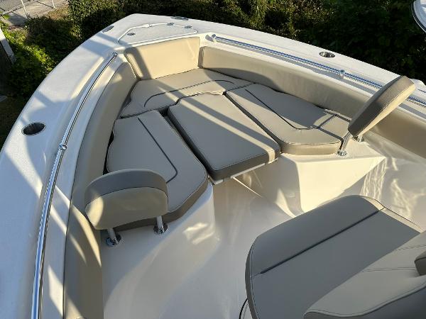 Slide: The Image of 2024 Key West 219 FS boat interior with beige seating and sleek design. - 5