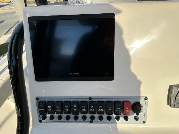 Slide: The Image of 2024 Key West 219 FS boat dashboard with Garmin display and control panel. - 8