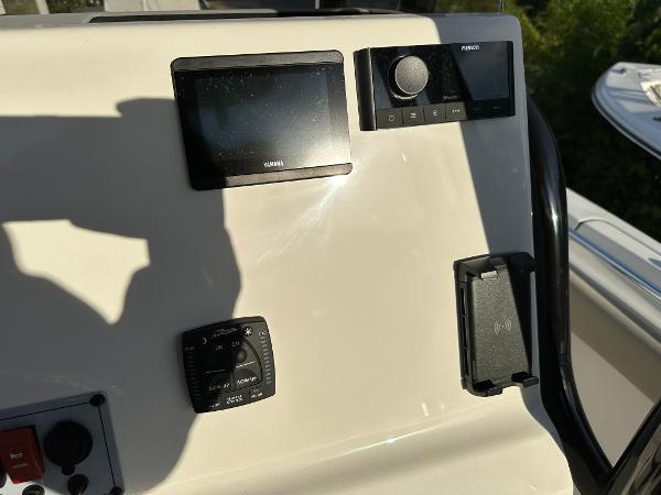 Slide: The Image of 2024 Key West 219 FS boat dashboard with Garmin display and controls. - 9