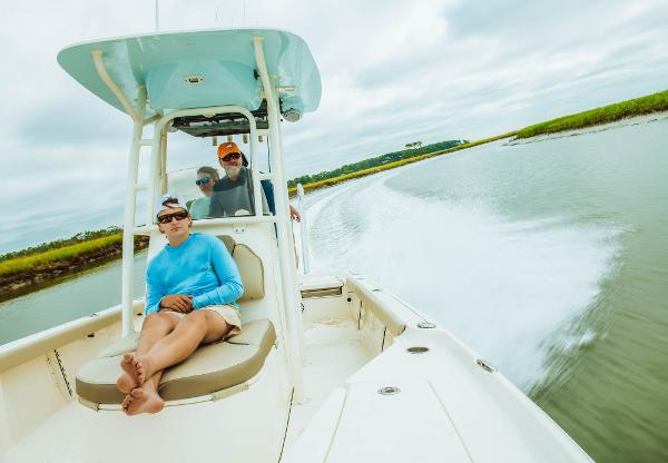 Slide: The Image of 2023 Key West 250 Bay Reef boat cruising with passengers on a scenic waterway. - 30