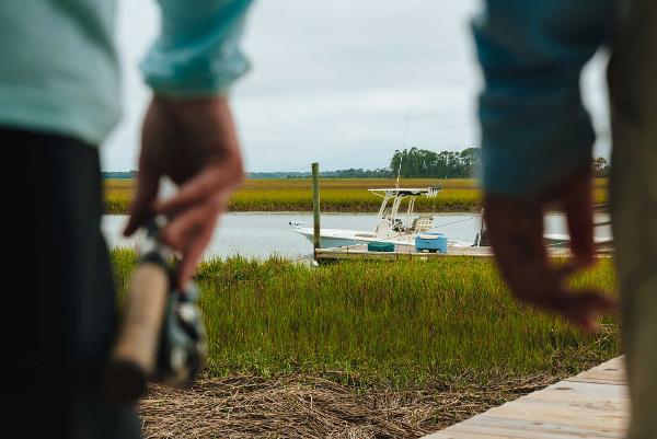 Slide: The Image of 2023 Key West 250 Bay Reef boat docked in a serene marshland setting - 32