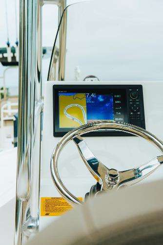 Slide: The Image of 2023 Key West 250 Bay Reef boat dashboard with navigation display. - 33