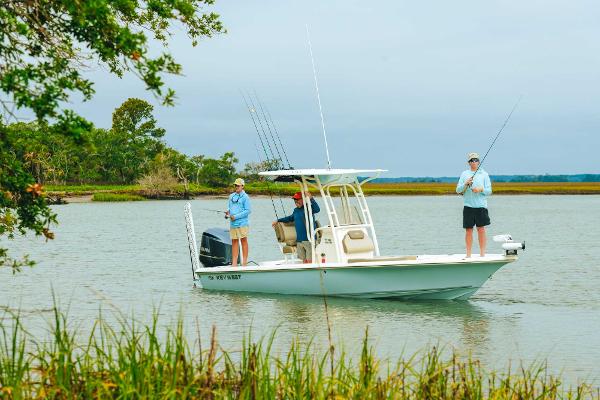 Slide: The Image of 2023 Key West 250 Bay Reef boat with anglers fishing in a serene lake. - 37