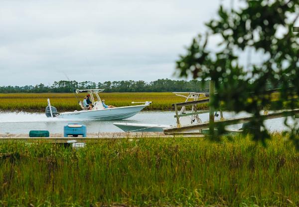 Slide: The Image of 2023 Key West 250 Bay Reef boat cruising through marshland. - 44