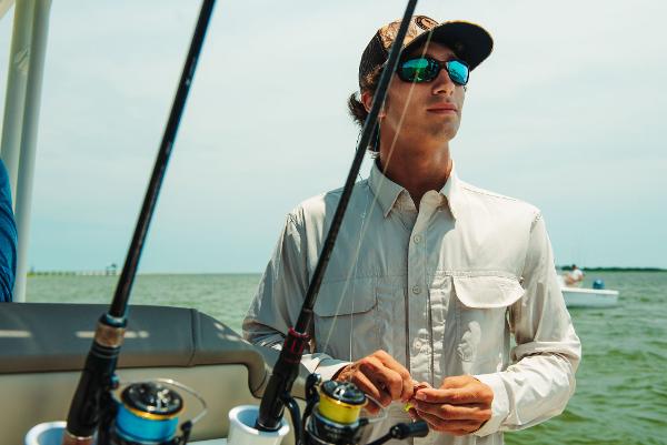 Slide: The Image of Man fishing on a 2023 Key West 250 Bay Reef boat. - 45