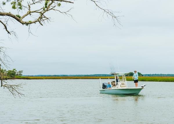Slide: The Image of 2023 Key West 250 Bay Reef boat on a calm lake with anglers fishing. - 46