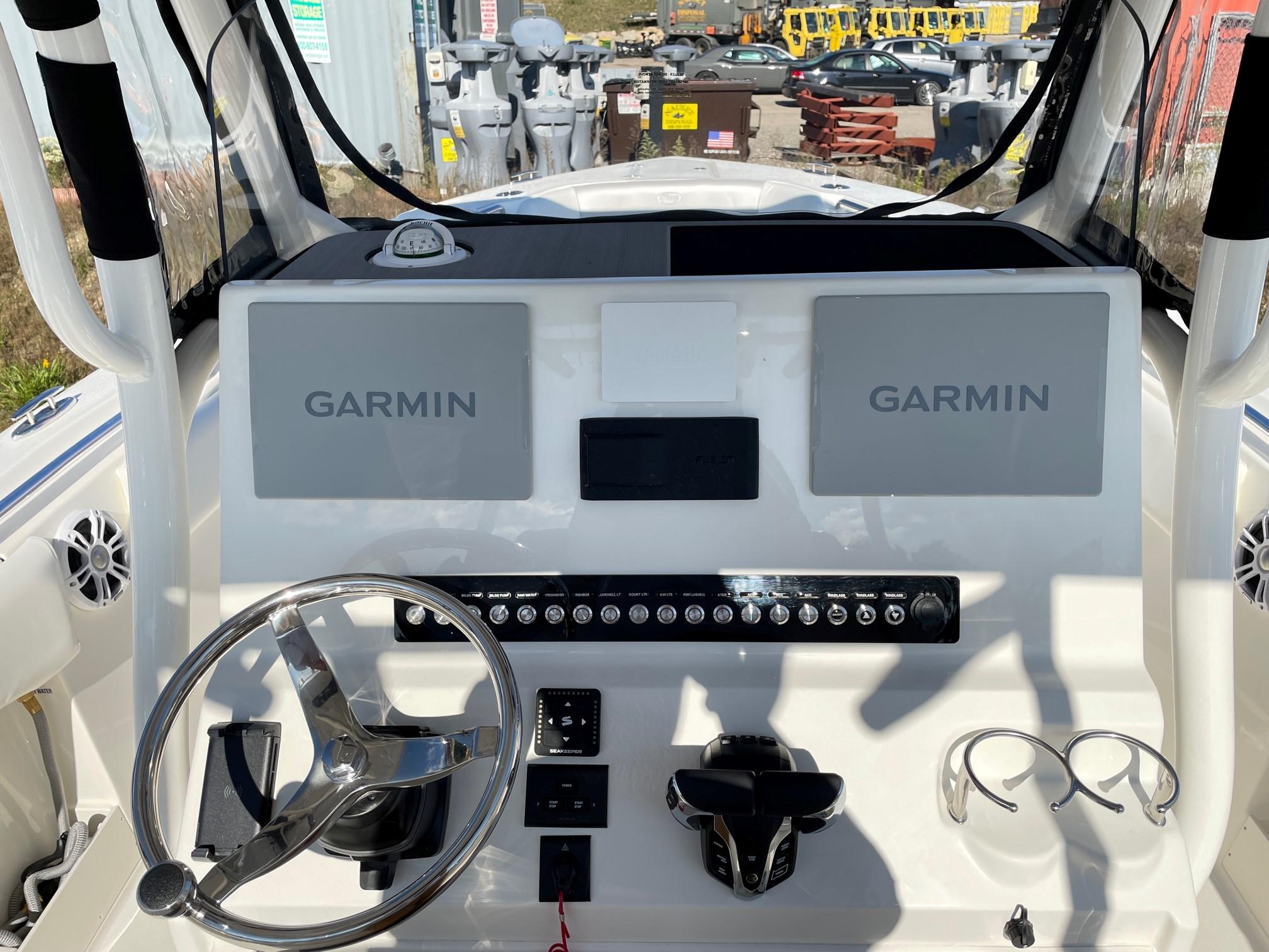 Slide: The Image of 2024 Key West 263 FS boat dashboard with Garmin navigation system and steering wheel. - 1