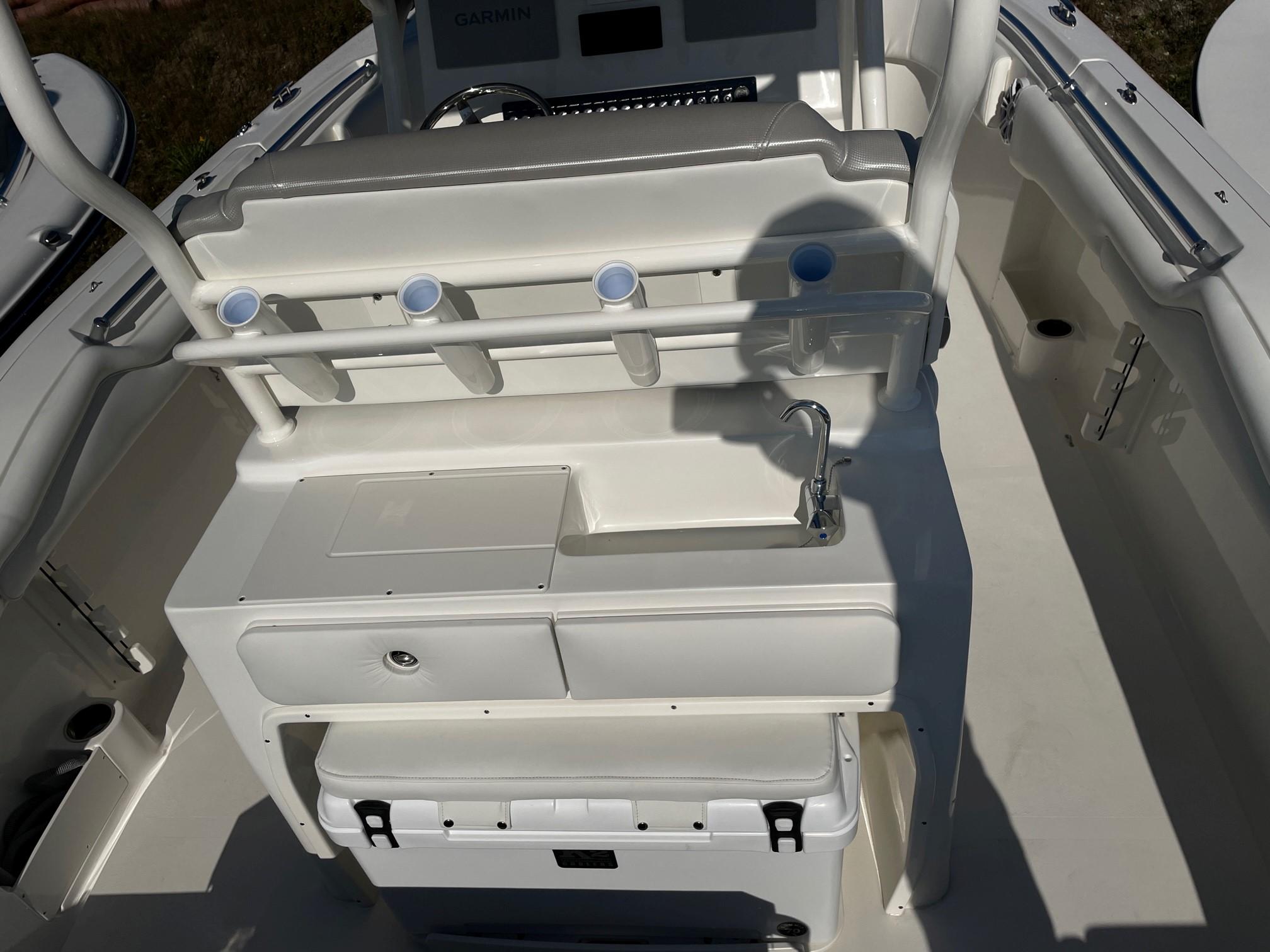 Slide: The Image of 2024 Key West 263 FS boat interior with rod holders and sink. - 2