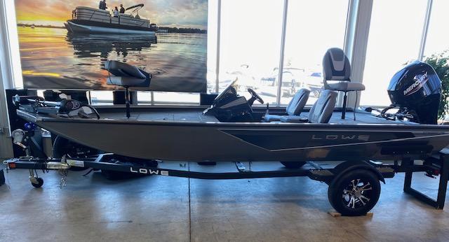 Slide: The Image of 2024 Lowe Stinger 175 Crappie fishing boat on display indoors. - 2