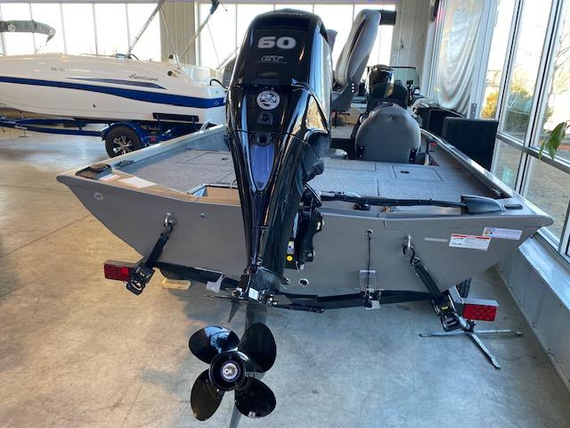 Slide: The Image of 2024 Lowe Stinger 175 Crappie boat with 60 HP outboard motor in showroom. - 4