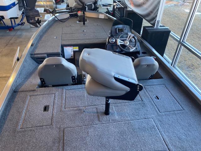 Slide: The Image of 2024 Lowe Stinger 175 Crappie fishing boat interior with seating and steering console. - 6