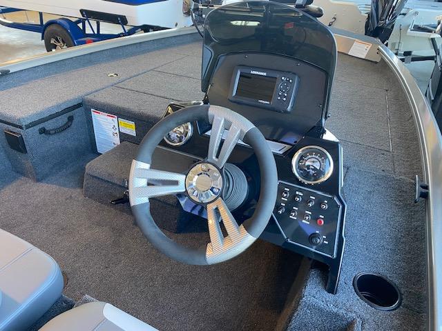 Slide: The Image of 2024 Lowe Stinger 175 Crappie boat interior with steering wheel and control panel. - 8
