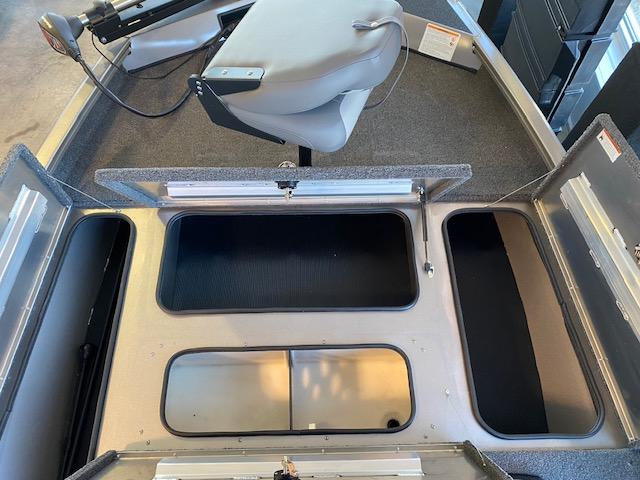 Slide: The Image of 2024 Lowe Stinger 175 Crappie boat interior with storage compartments and seating. - 9