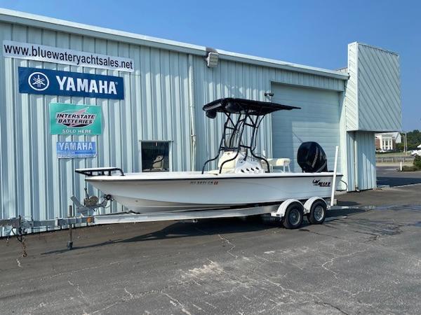 Slide: The Image of 2011 Mako 2201 Inshore boat on trailer outside Yamaha dealership. - 0