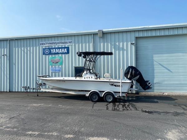 Slide: The Image of 2011 Mako 2201 Inshore boat on trailer outside Yamaha dealership. - 1