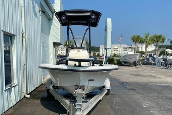 Slide: The Image of 2011 Mako 2201 Inshore boat on trailer, parked outside a building. - 3