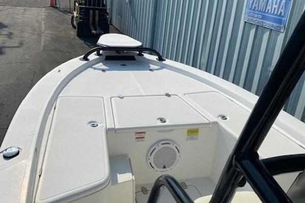 Slide: The Image of 2011 Mako 2201 Inshore boat deck, white with storage compartments. - 5