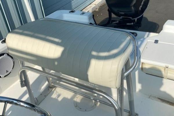 Slide: The Image of Mako 2201 Inshore 2011 boat seat with white upholstery and metal frame. - 6
