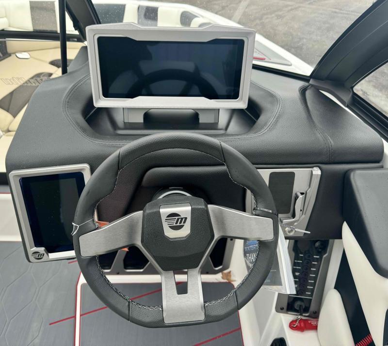 Slide: The Image of 2024 Malibu M220 boat dashboard with modern steering wheel and digital displays. - 12