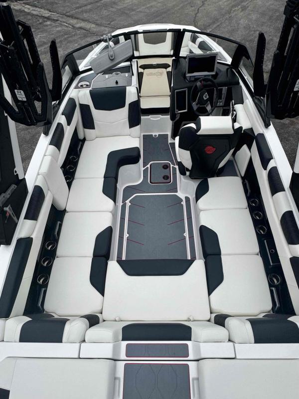 Slide: The Image of 2024 Malibu M220 boat interior with sleek seating and modern dashboard design. - 14