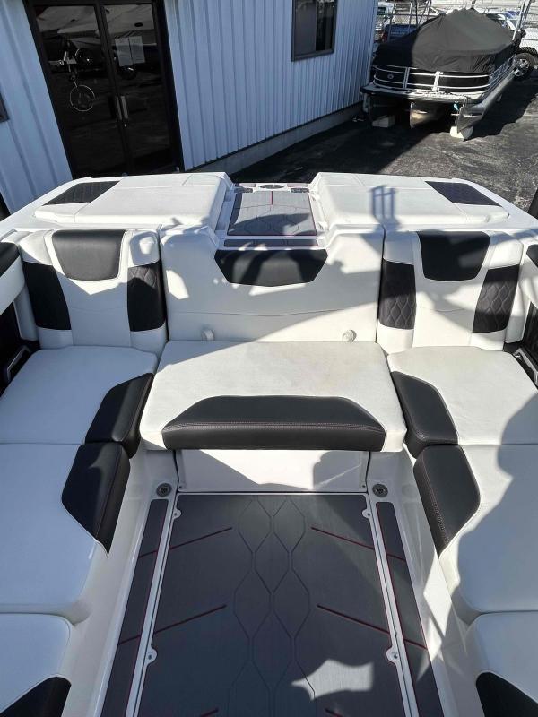 Slide: The Image of 2024 Malibu M220 boat interior with white and black seating. - 15