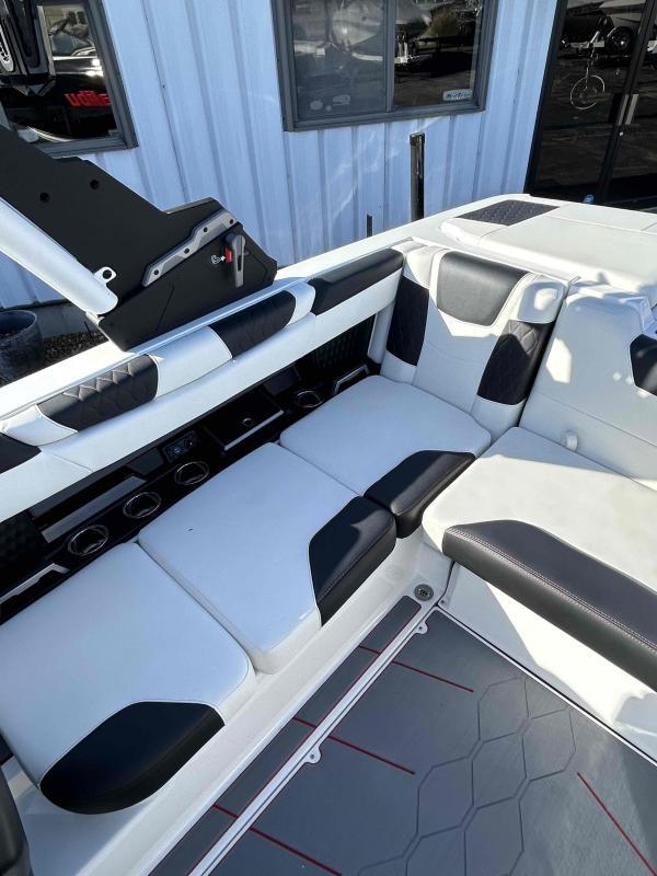 Slide: The Image of 2024 Malibu M220 boat interior with white and black seating. - 16