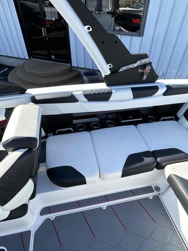 Slide: The Image of 2024 Malibu M220 boat interior with white and black seating, modern design. - 17