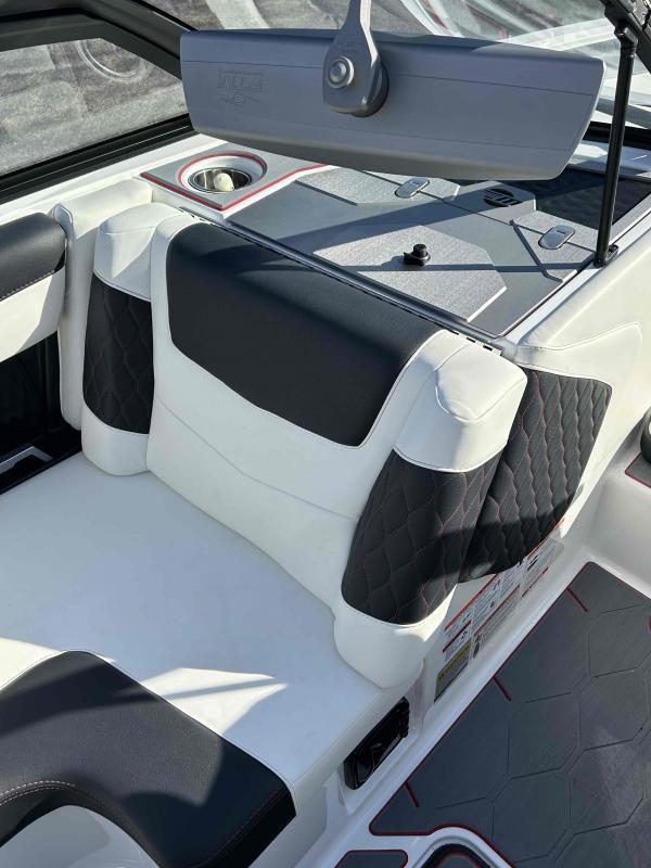 Slide: The Image of 2024 Malibu M220 boat interior with white and black seating. - 18