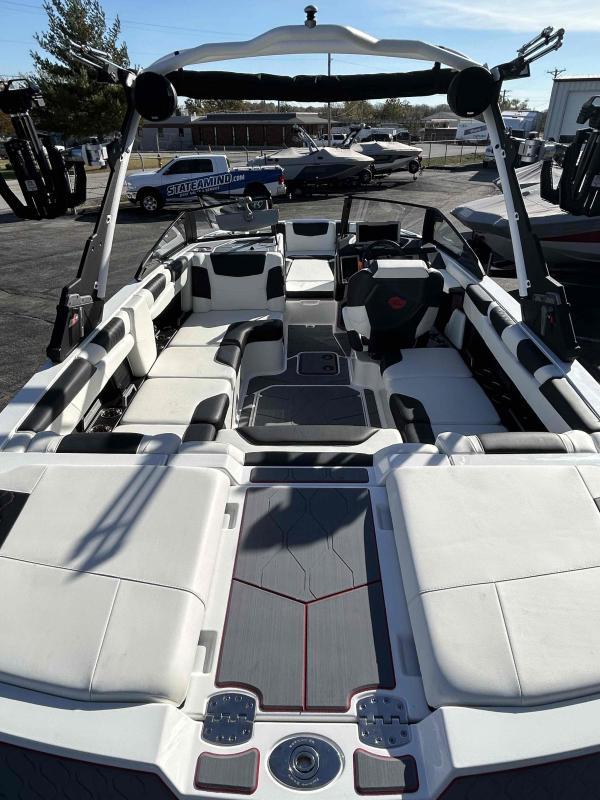 Slide: The Image of 2024 Malibu M220 boat interior with white and black seating, and modern dashboard. - 21
