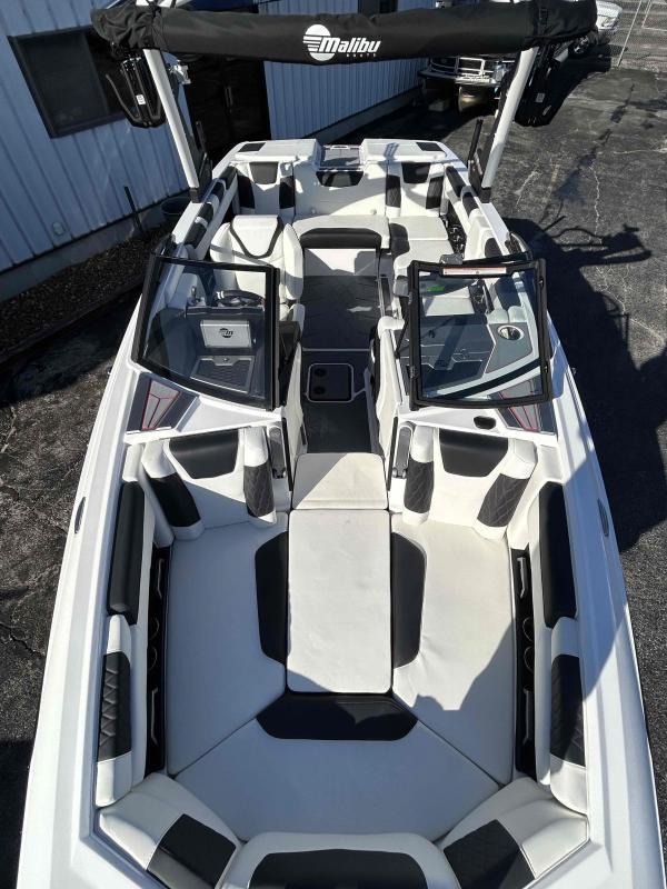 Slide: The Image of 2024 Malibu M220 boat interior with white and black seating. - 9