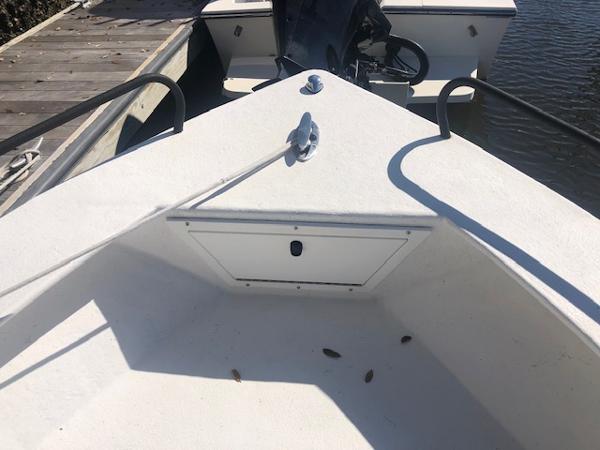 Slide: The Image of 2021 May-Craft 1800 Skiff boat docked, showing bow storage compartment. - 15