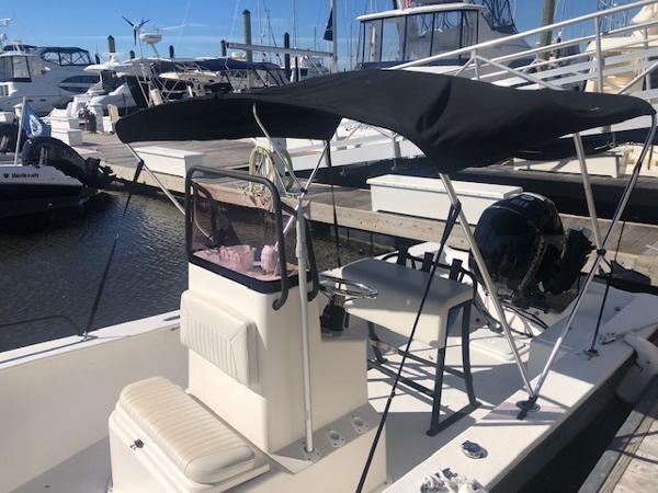 Slide: The Image of 2021 May-Craft 1800 Skiff boat docked at a marina with a black canopy. - 16