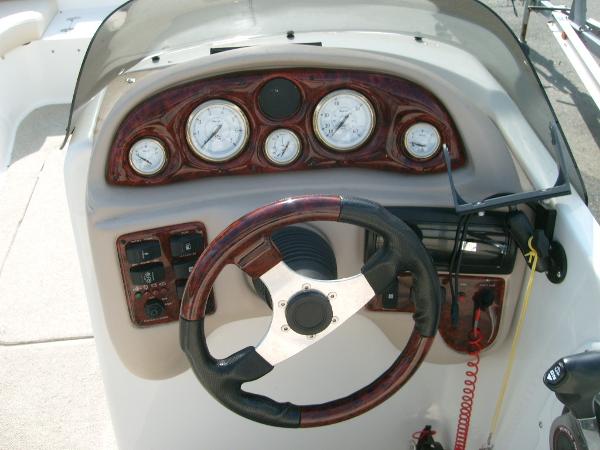 Slide: The Image of Dashboard of 2005 NauticStar 210 Sport Deck boat with gauges and steering wheel. - 5