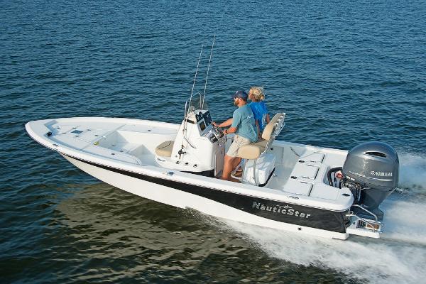 Slide: The Image of 2023 NauticStar 215 XTS boat cruising on open water. - 1
