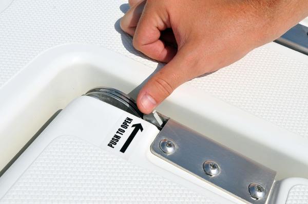 Slide: The Image of Hand opening compartment on 2023 NauticStar 215 XTS boat. - 10