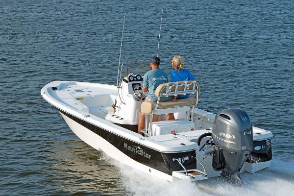 Slide: The Image of 2023 NauticStar 215 XTS boat cruising on water with two passengers. - 2