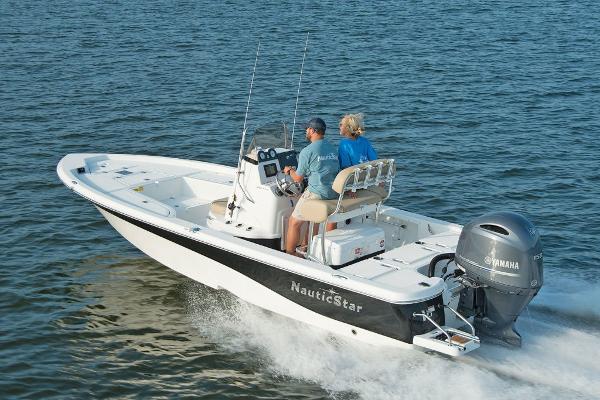 Slide: The Image of 2023 NauticStar 215 XTS boat cruising on water. - 3