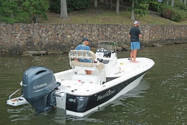Slide: The Image of 2023 NauticStar 215 XTS boat with Yamaha engine on a lake. - 5