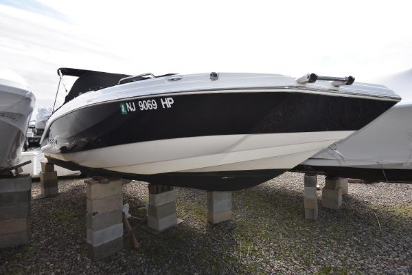 Slide: The Image of 2021 NauticStar 223 DC boat on blocks, black and white hull, side view. - 1
