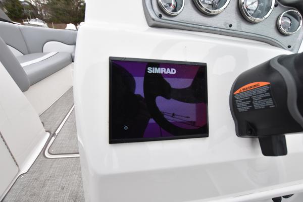 Slide: The Image of 2021 NauticStar 223 DC boat dashboard with Simrad display and control panel. - 13