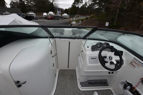 Slide: The Image of 2021 NauticStar 223 DC boat cockpit with steering wheel and dashboard. - 4