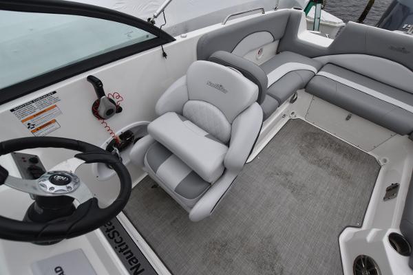 Slide: The Image of 2021 NauticStar 223 DC boat interior with steering wheel and seating. - 6
