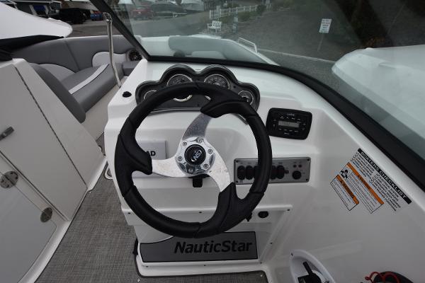 Slide: The Image of 2021 NauticStar 223 DC boat steering console and dashboard. - 9