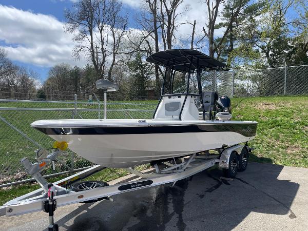 Slide: The Image of 2023 NauticStar 227 Bay boat on trailer, parked outdoors. - 1