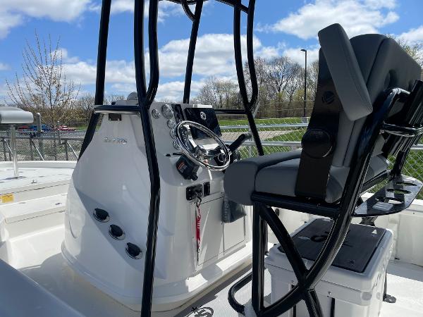 Slide: The Image of 2023 NauticStar 227 Bay boat console and seating area. - 4